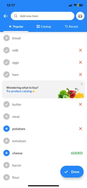 The same Listonic add-item screen mid-shop, with cheese added and items ticked