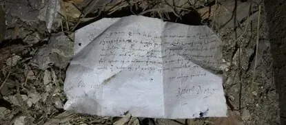 A folded seventeenth-century letter lying among dust and debris